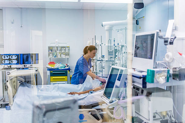 Doctor using electrode on patient in operating theatre.